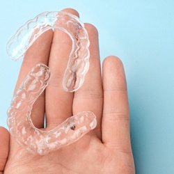 clear aligners representing cost of Invisalign in Highland Park